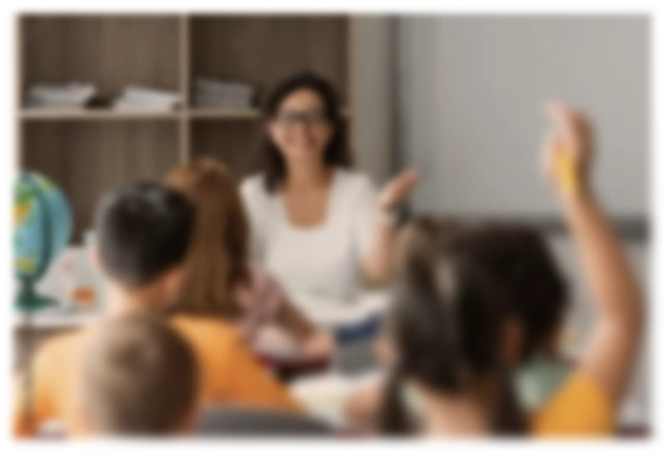 An education researcher interacts with elementary-aged students in a classroom setting