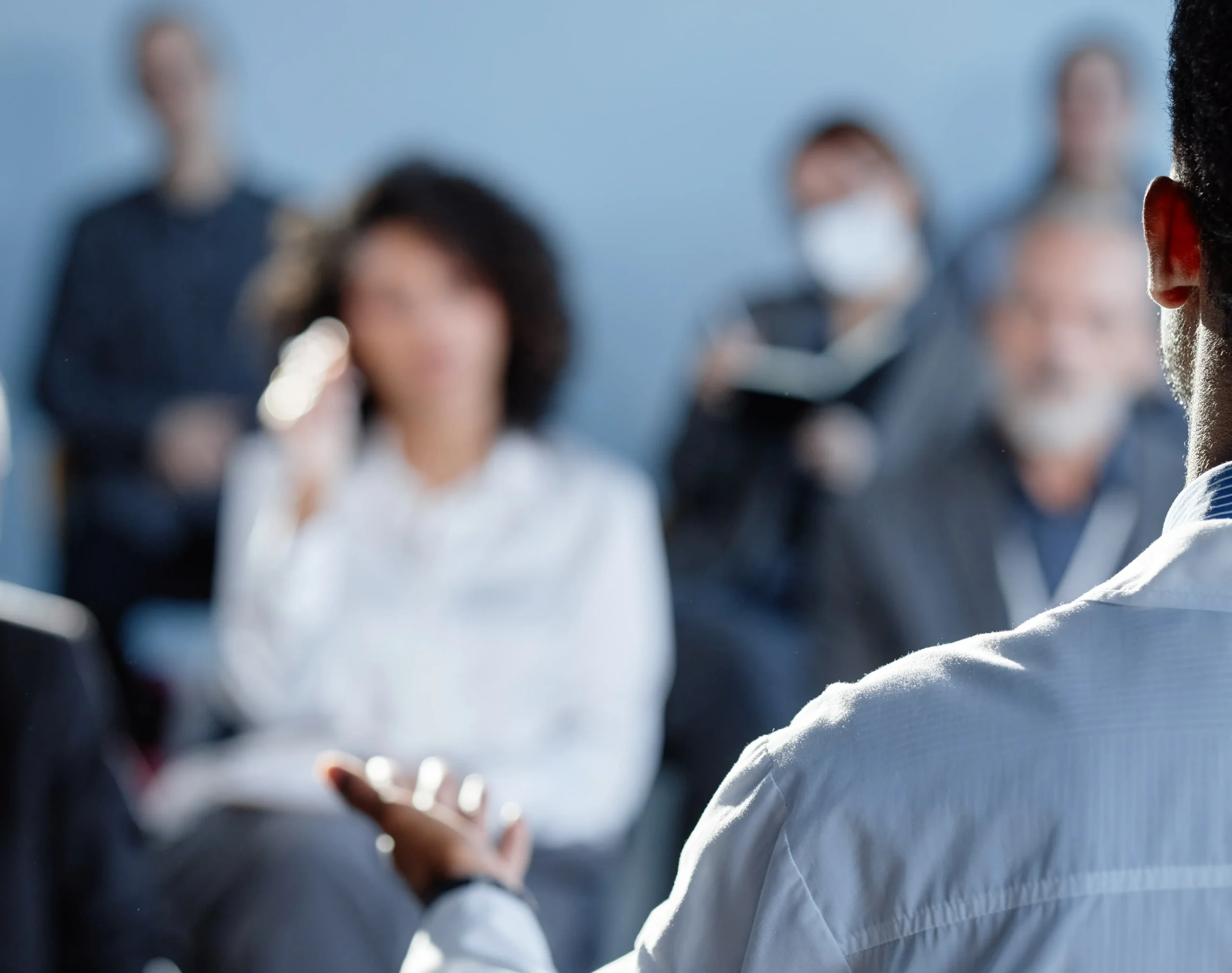 Business professional speaking to an audience during a corporate meeting or presentation session.