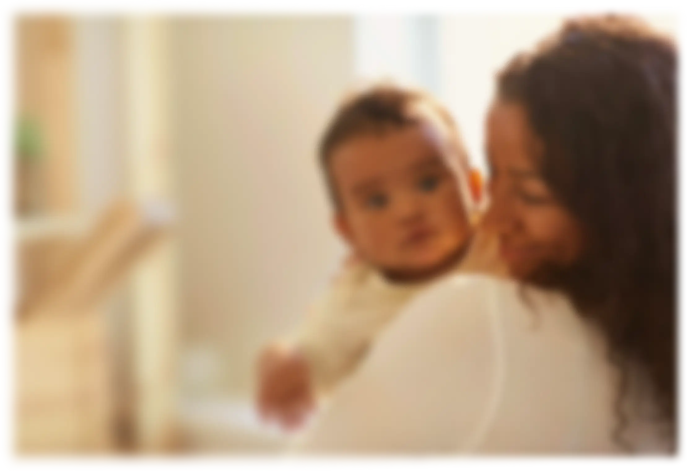 A mother who has benefitted from early childhood research holds her baby